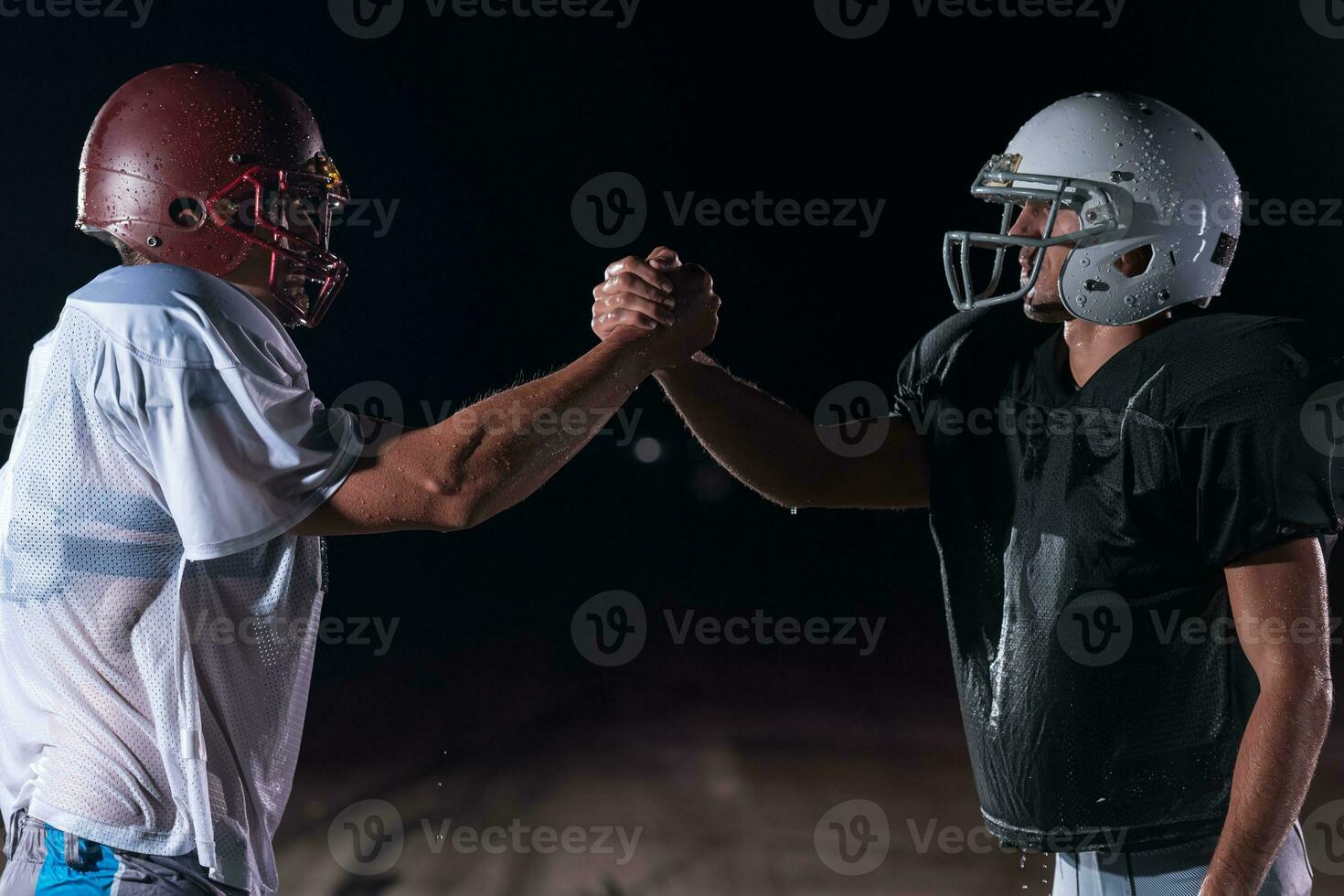 two american football players face to face in silhouette shadow on white background photo