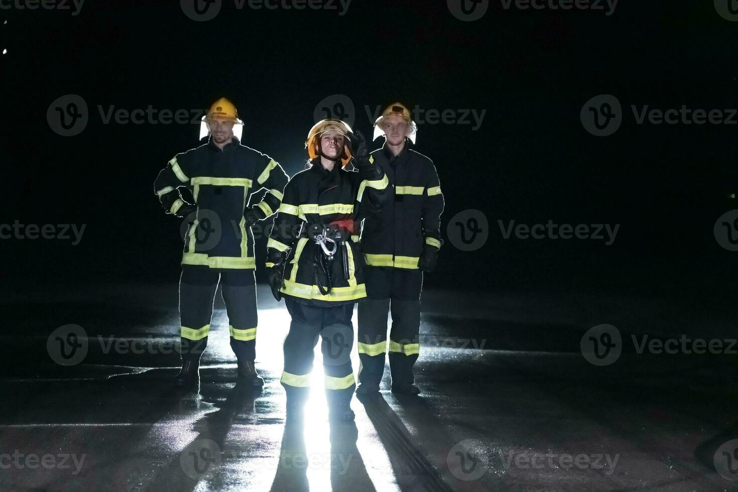 Portrait of a group of firefighters standing and walking brave and optimistic with a female as team leader. photo