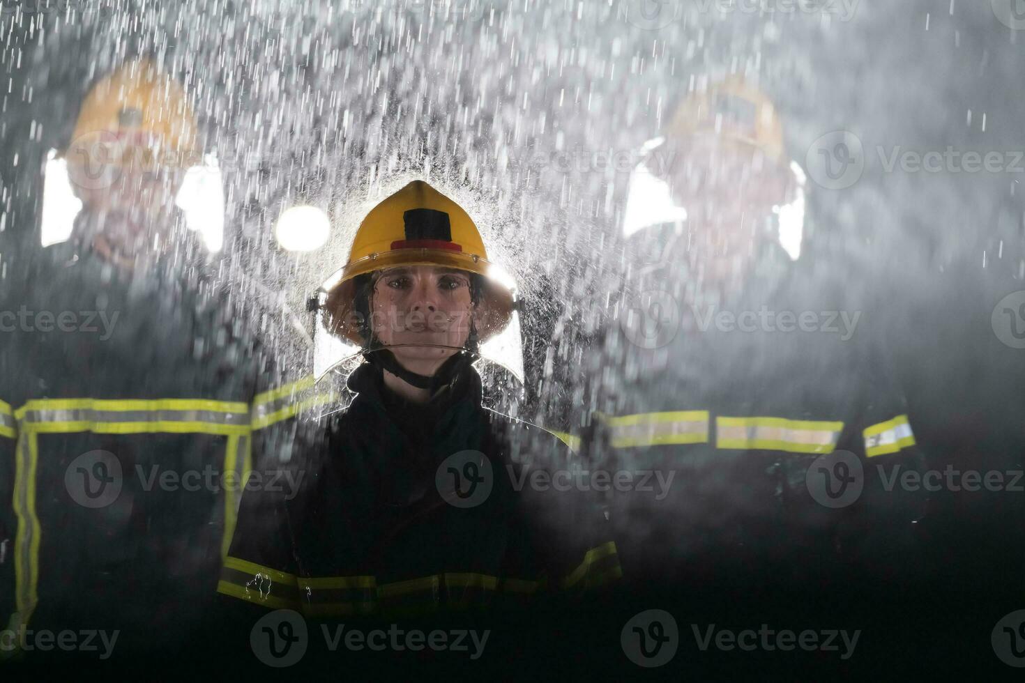 Portrait of a group of firefighters standing and walking brave and optimistic with a female as team leader. photo