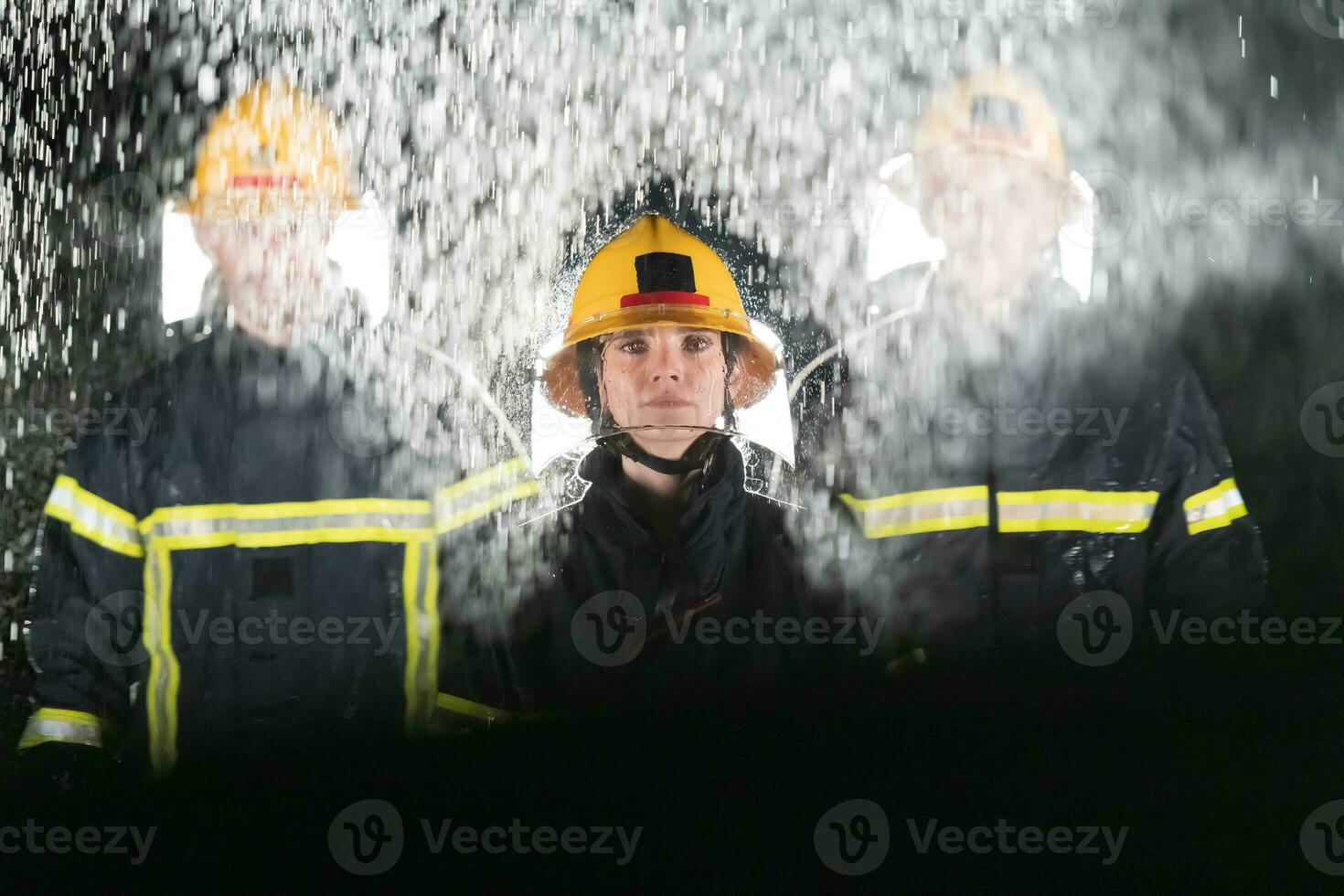 Portrait of a group of firefighters standing and walking brave and optimistic with a female as team leader. photo