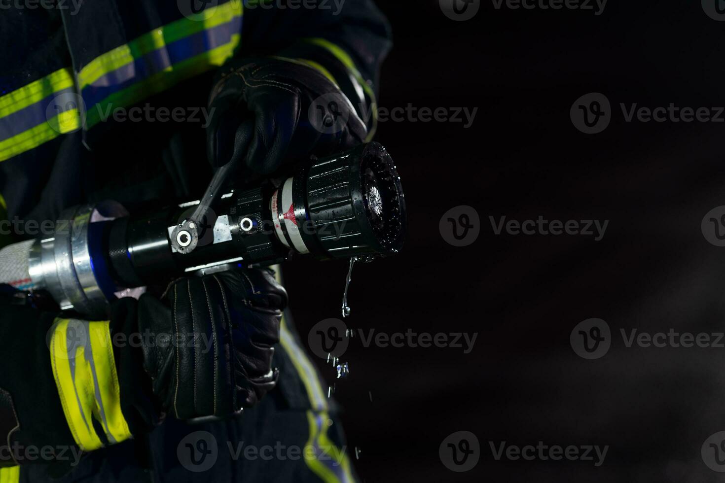Firefighters use a water hose to eliminate a fire hazard. Team of firemen in the dangerous rescue mission. photo
