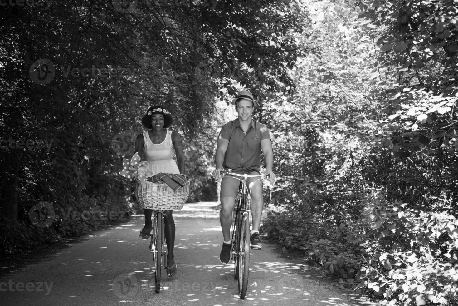 Young multiethnic couple having a bike ride in nature photo