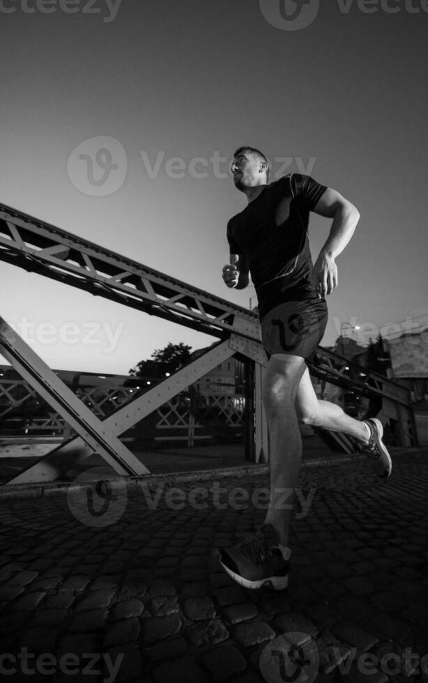 man jogging across the bridge in the city photo