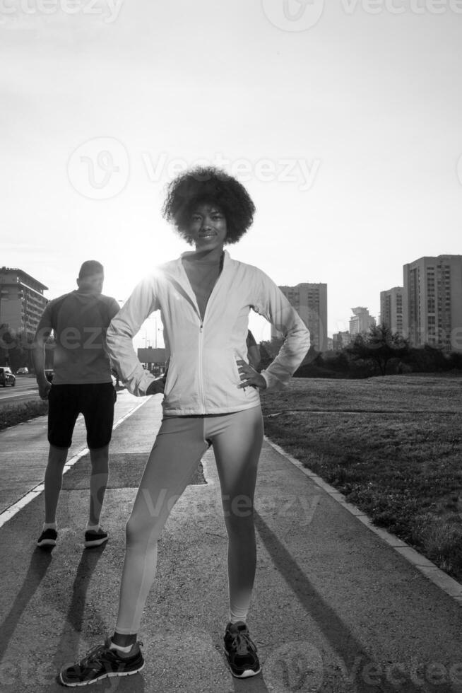 Portrait of sporty young african american woman running outdoors photo