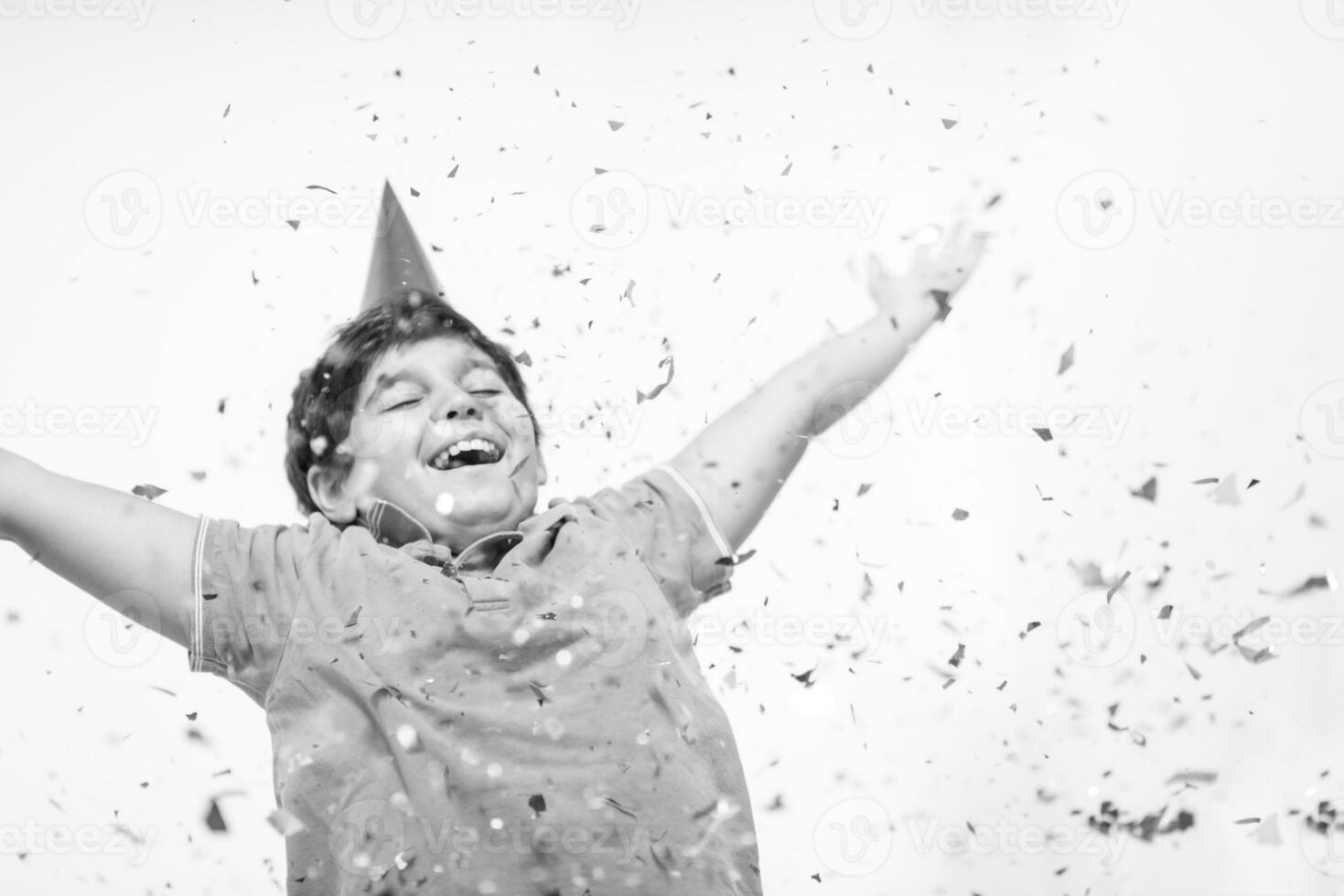kid blowing confetti photo