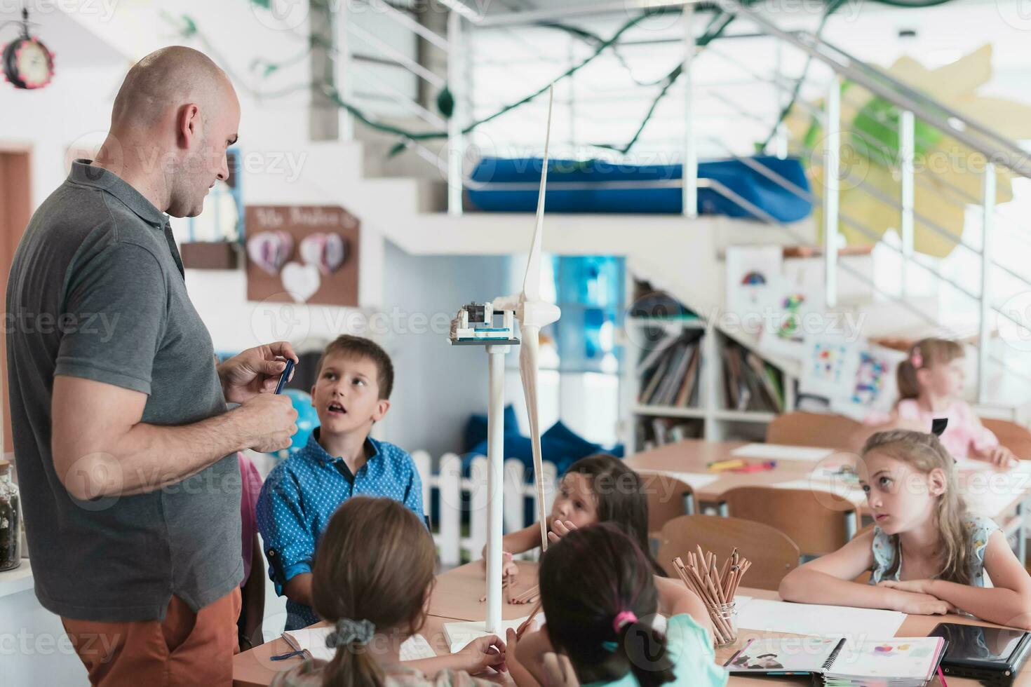 Elementary School Stem Robotics Classroom Diverse Group of Children Building and Programming windmill ecology robot concept. Together Talking and Working as a Team. Creative Robotics Engineering photo