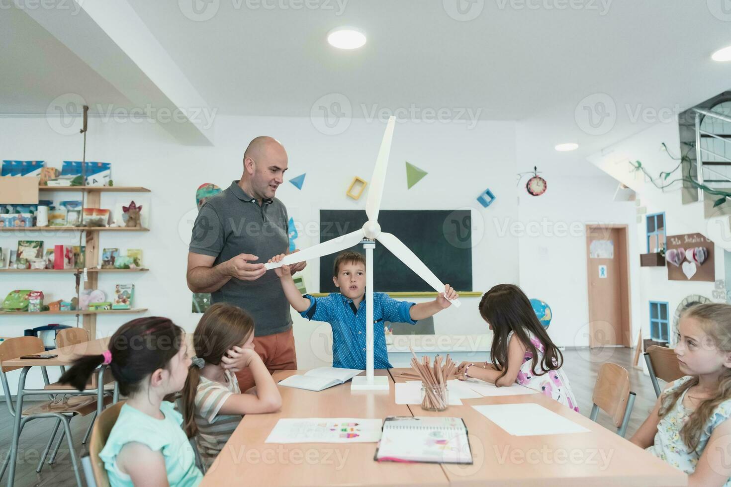 Elementary School Stem Robotics Classroom Diverse Group of Children Building and Programming windmill ecology robot concept. Together Talking and Working as a Team. Creative Robotics Engineering photo