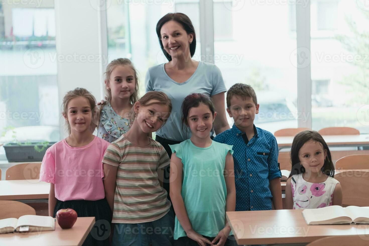 Portrait of children in a preschool institution with their teacher in a torn classroom. Selective focus photo