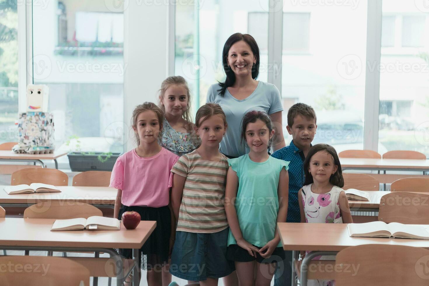 Portrait of children in a preschool institution with their teacher in a torn classroom. Selective focus photo