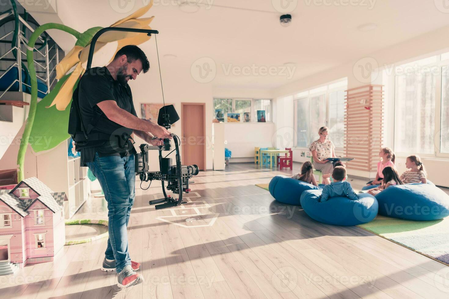 Video operator. Videography.Filming.A man is shooting a video.The work of a videographer. Shooting with a professional camera with a tripod. A man shoots on a professional video camera.Videographer photo