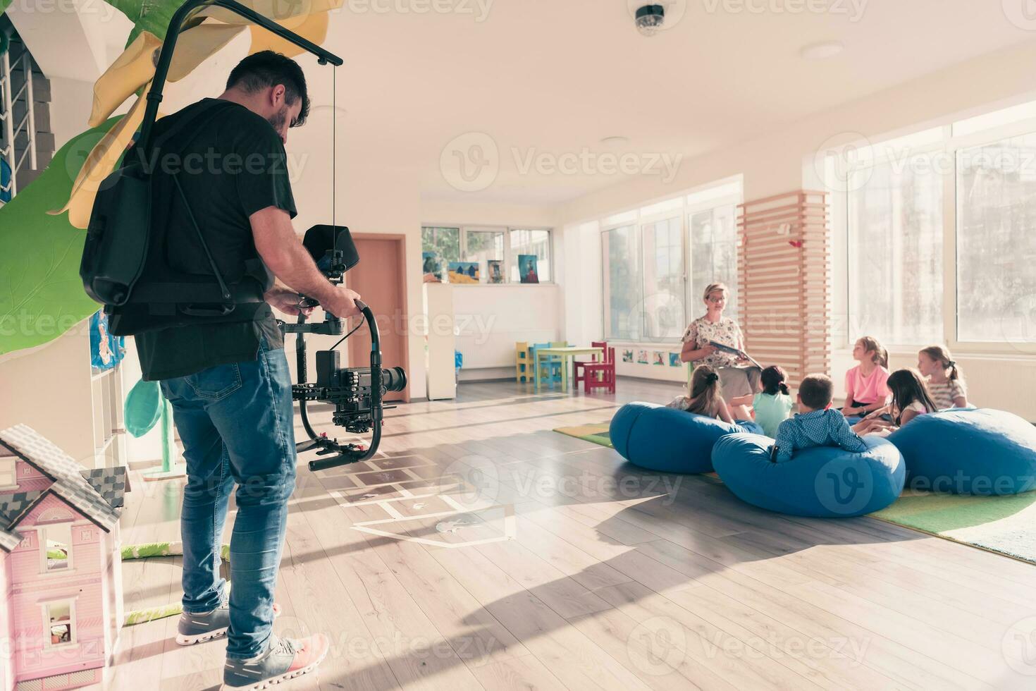 Video operator. Videography.Filming.A man is shooting a video.The work of a videographer. Shooting with a professional camera with a tripod. A man shoots on a professional video camera.Videographer photo