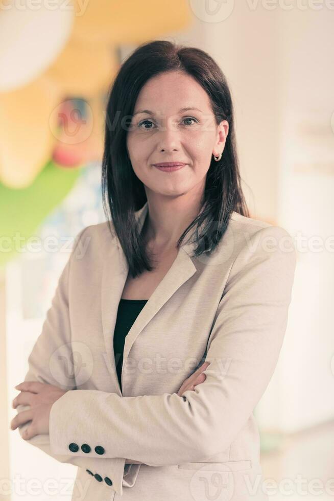 Young businesswoman smiling happy with arms crossed. Selctive focus photo