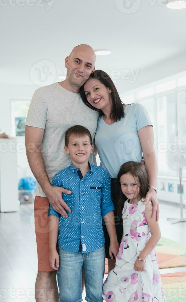 Portrait of a happy family. Photo of parents with children in a modern preschool classroom. Selective focus