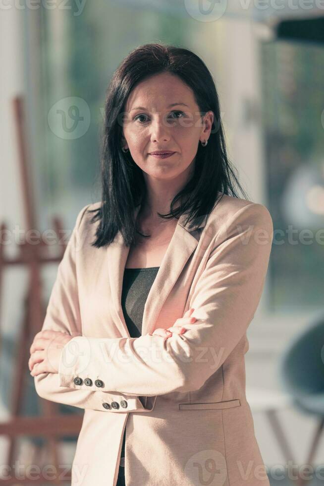 Young businesswoman smiling happy with arms crossed. Selctive focus photo