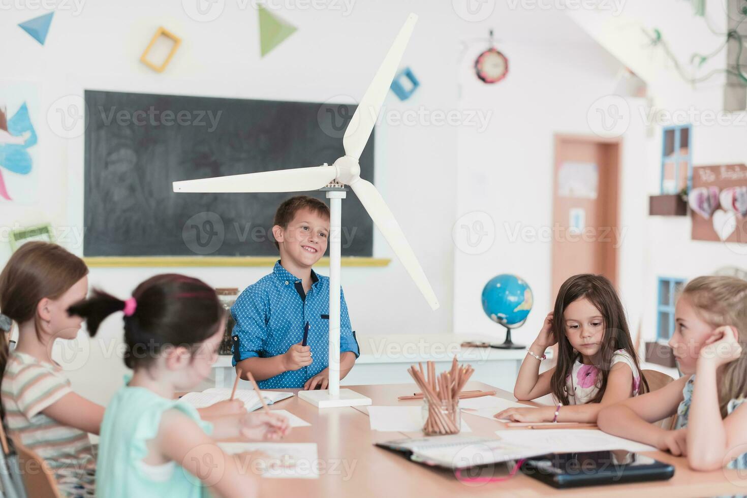 Elementary School Stem Robotics Classroom Diverse Group of Children Building and Programming windmill ecology robot concept. Together Talking and Working as a Team. Creative Robotics Engineering photo