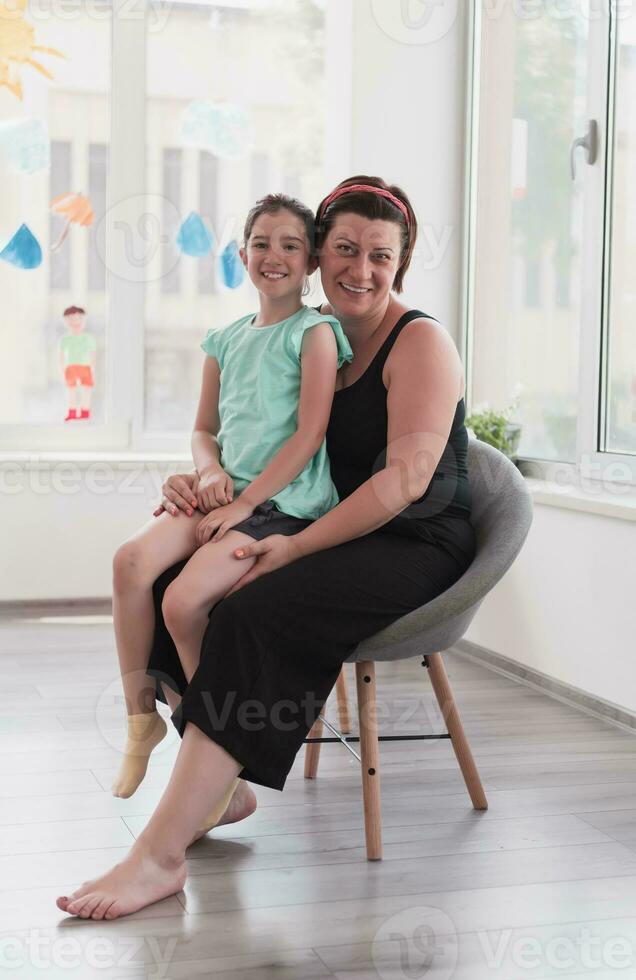 Portrait of a mother and daughter in a modern institution for preschool education photo