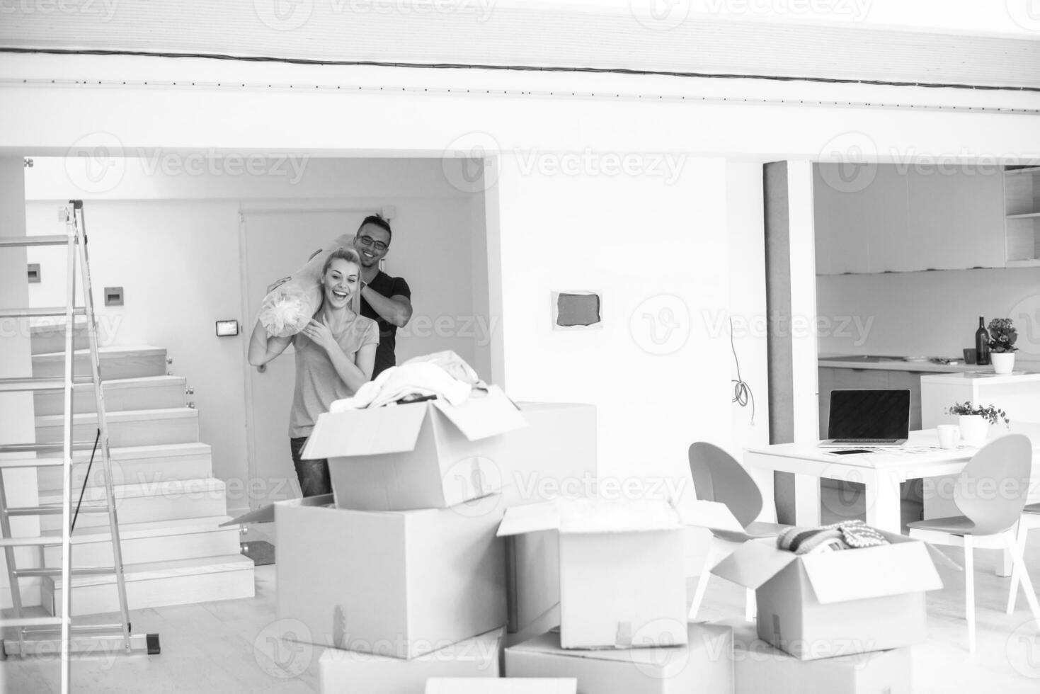 couple carrying a carpet moving in to new home photo
