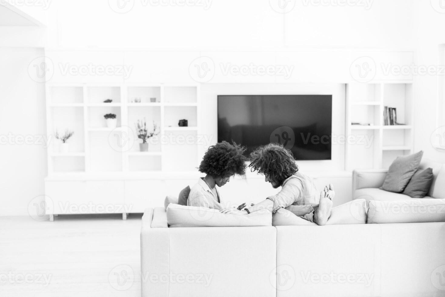 multiethnic couple in living room photo