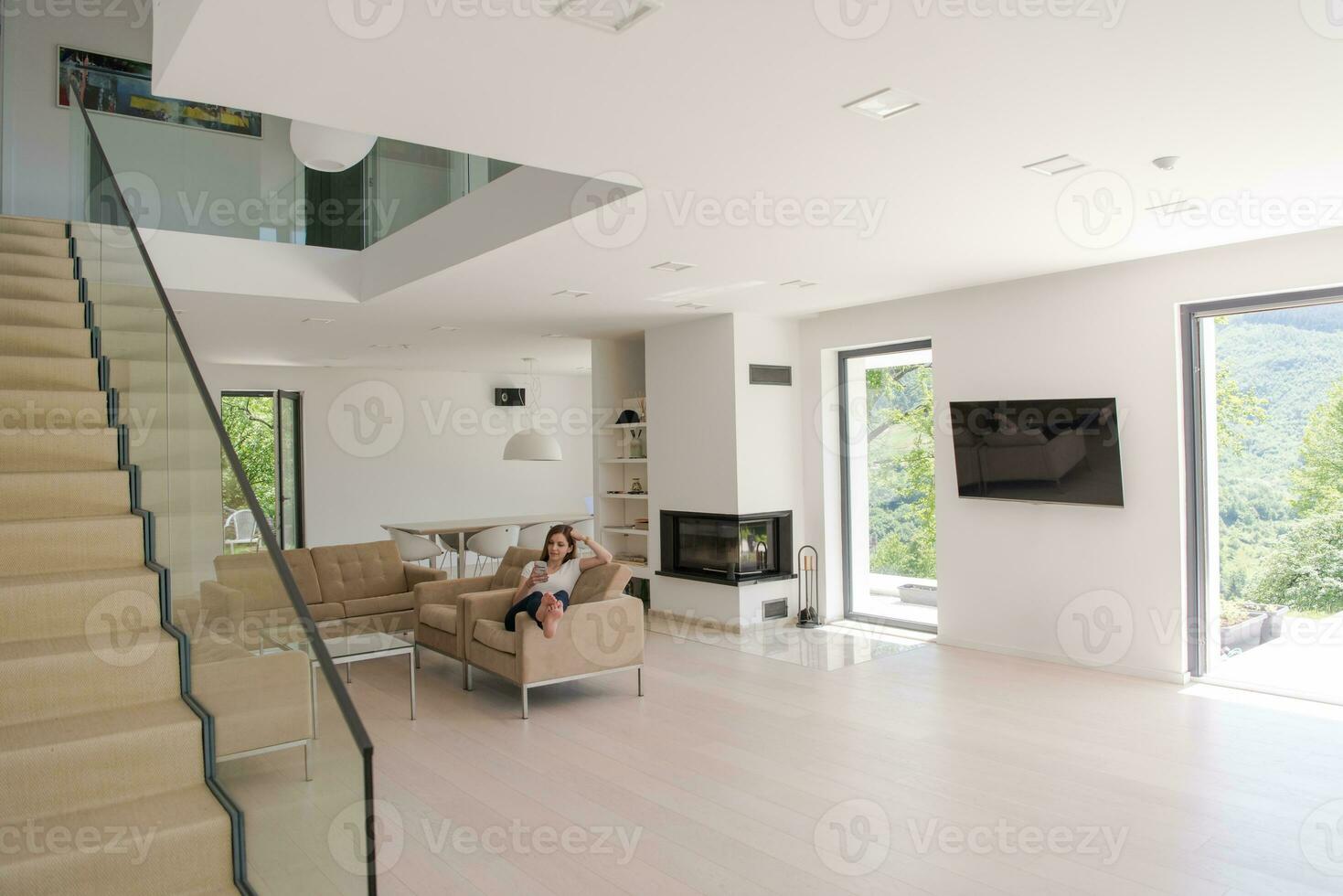 woman sitting on sofa with mobile phone photo