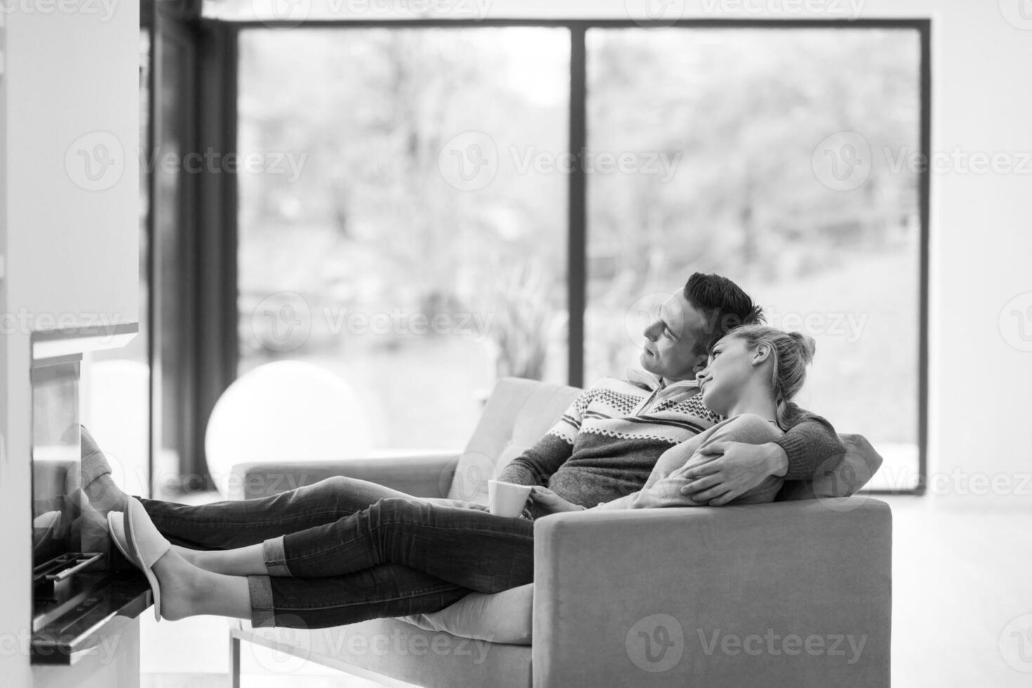 Young couple  in front of fireplace photo