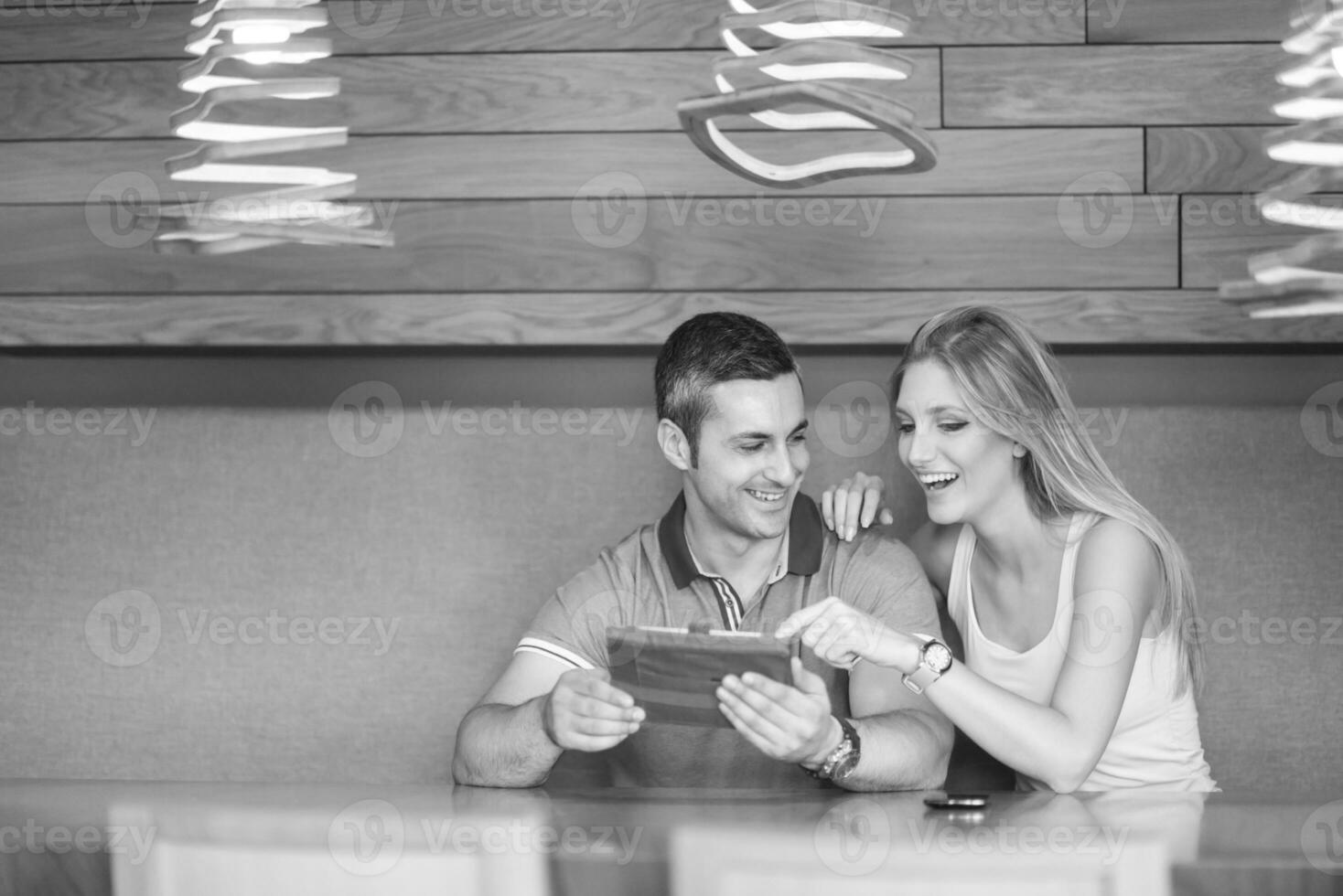 couple using tablet at home photo