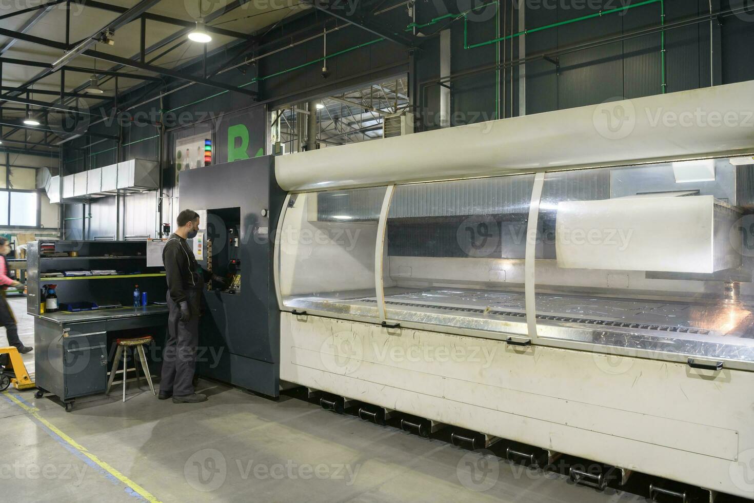 A smart factory worker or engineer wears a face mask because of a pandemic and makes machines in a production workshop. The concept of industry and engineering. photo