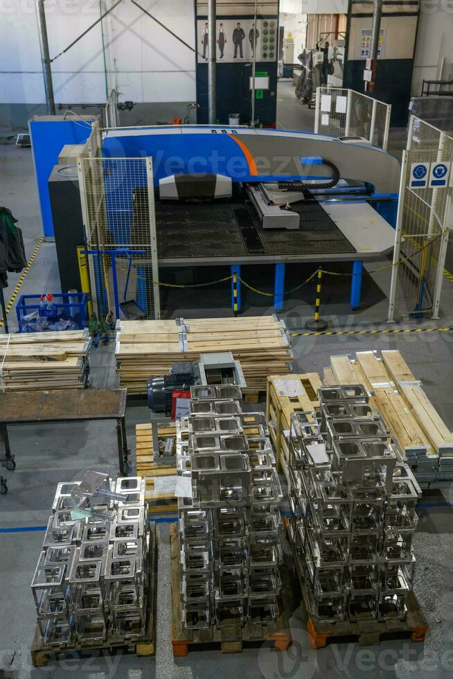 The first phase of metal and aluminum processing. Processed products from CNC machines stacked on a pallet in a large modern factory photo