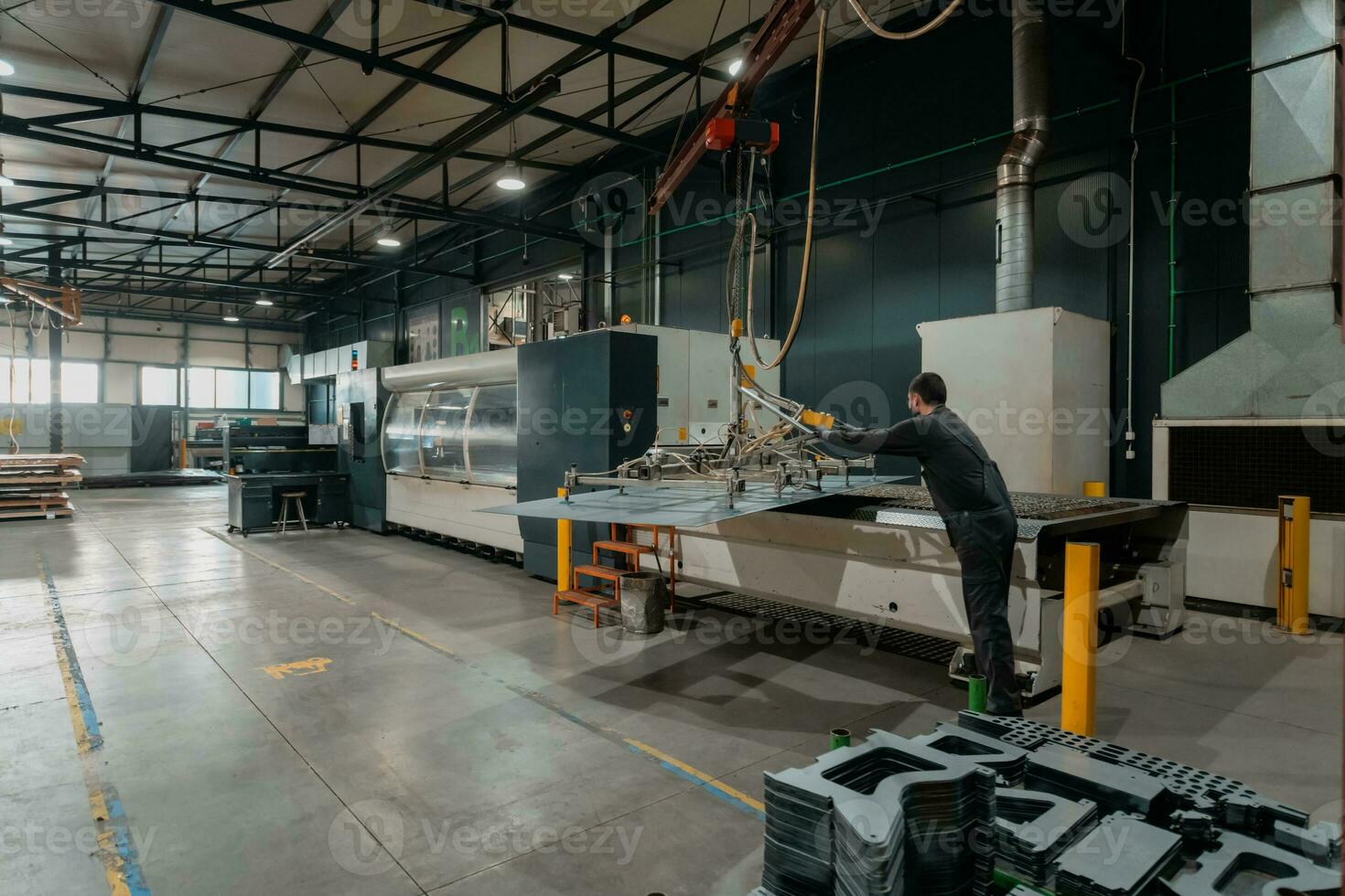 A smart factory worker or engineer wears a face mask because of a pandemic and makes machines in a production workshop. The concept of industry and engineering. photo