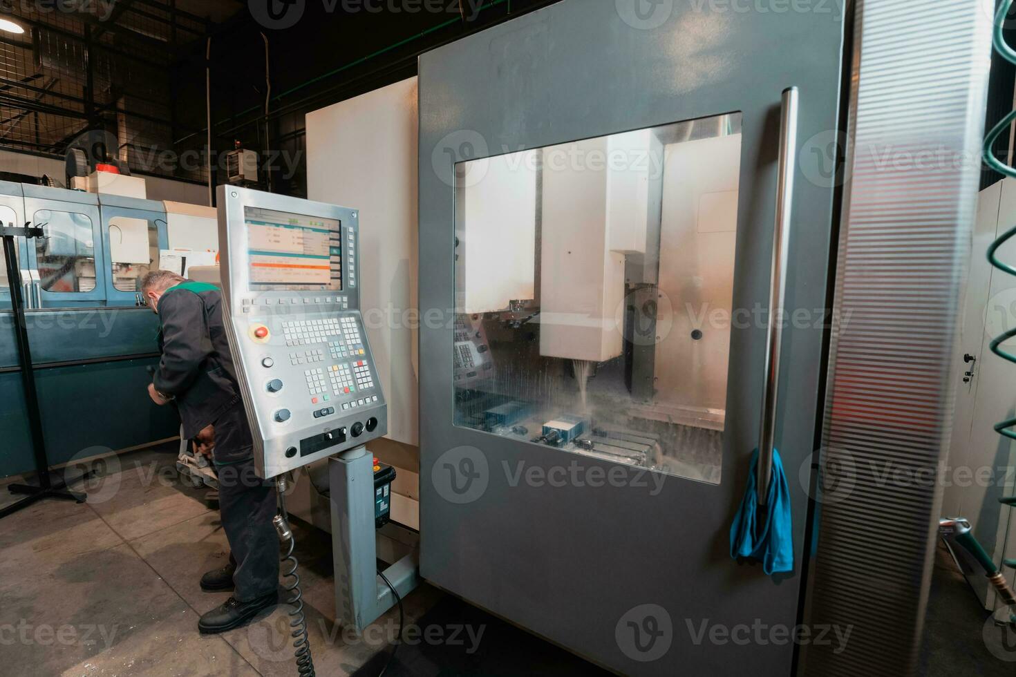 A smart factory worker or engineer wears a face mask because of a pandemic and makes machines in a production workshop. The concept of industry and engineering. photo