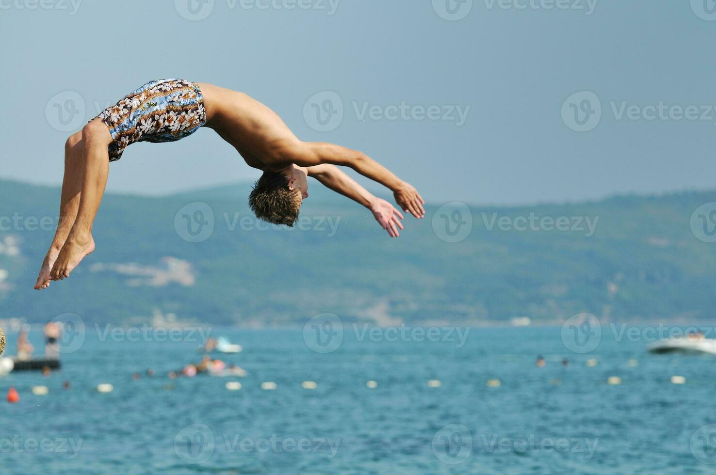 boy jump sea photo