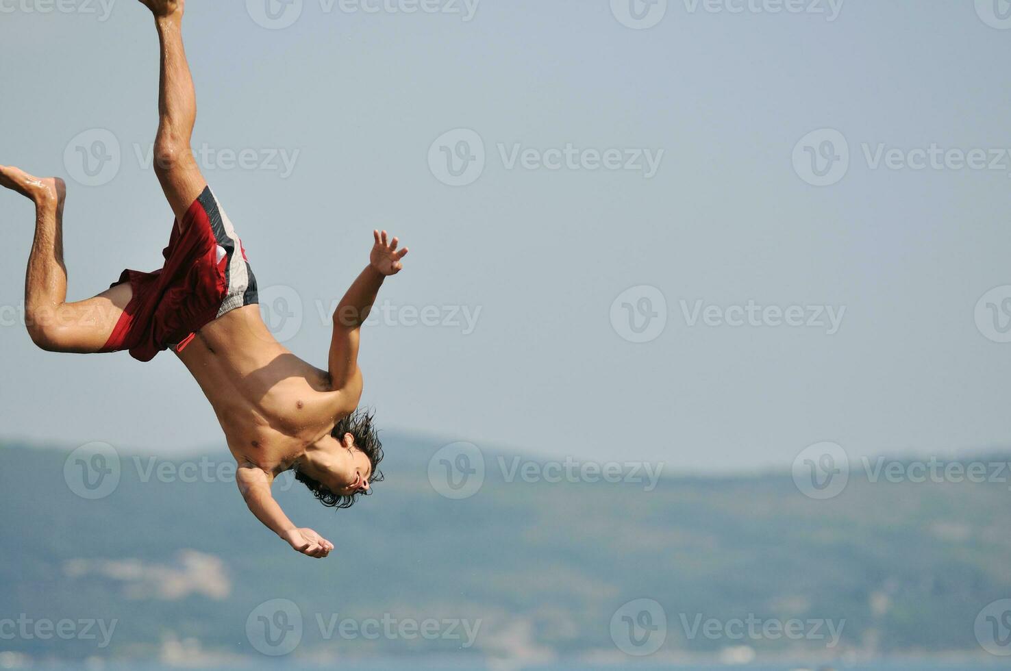 boy jump sea photo