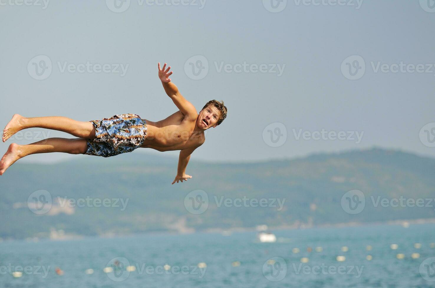 boy jump sea photo