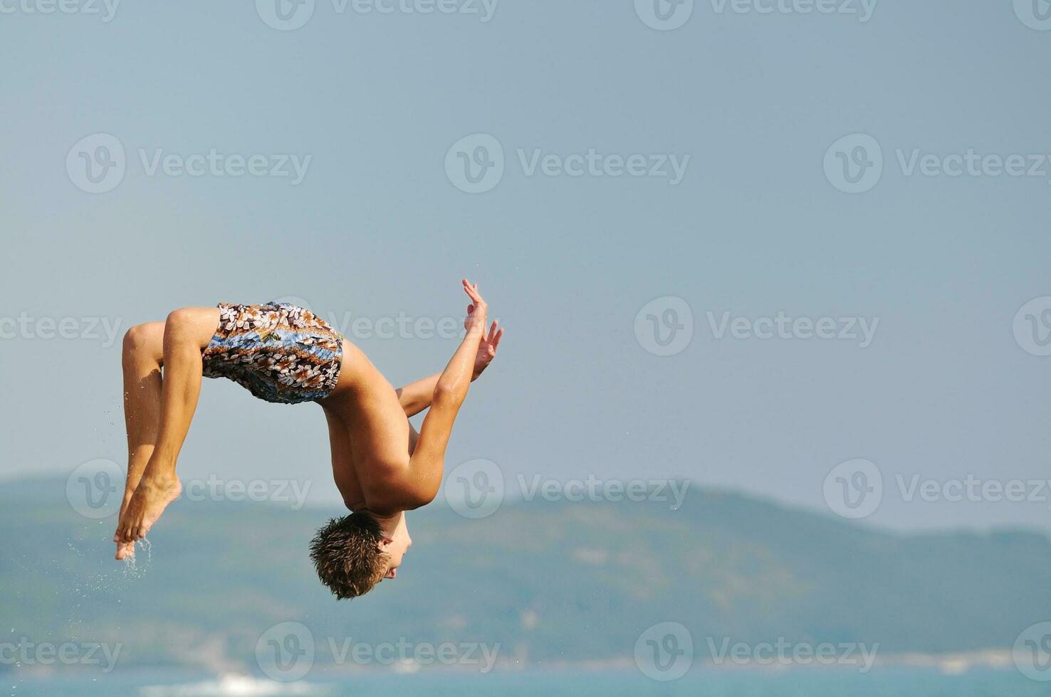 boy jump sea photo