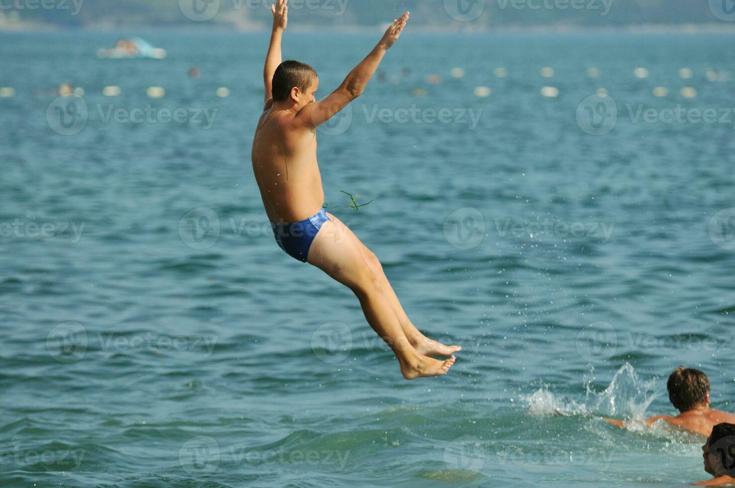 boy jump sea photo