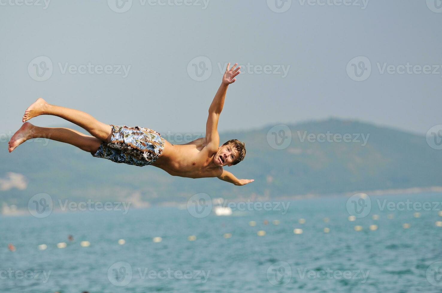 boy jump sea photo