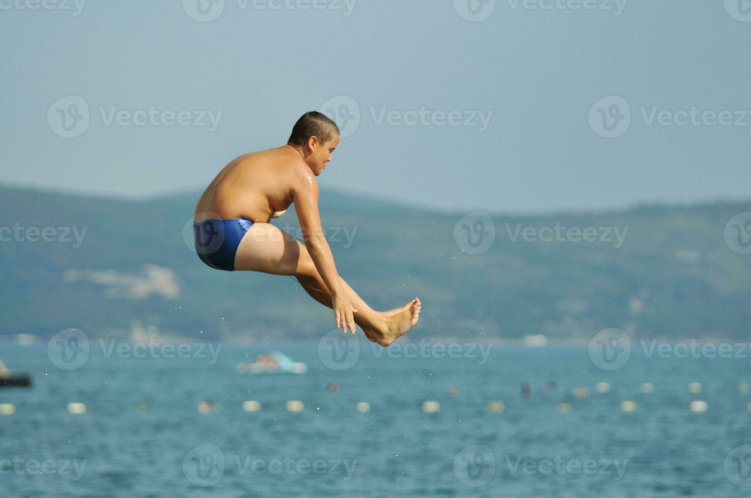 boy jump sea photo