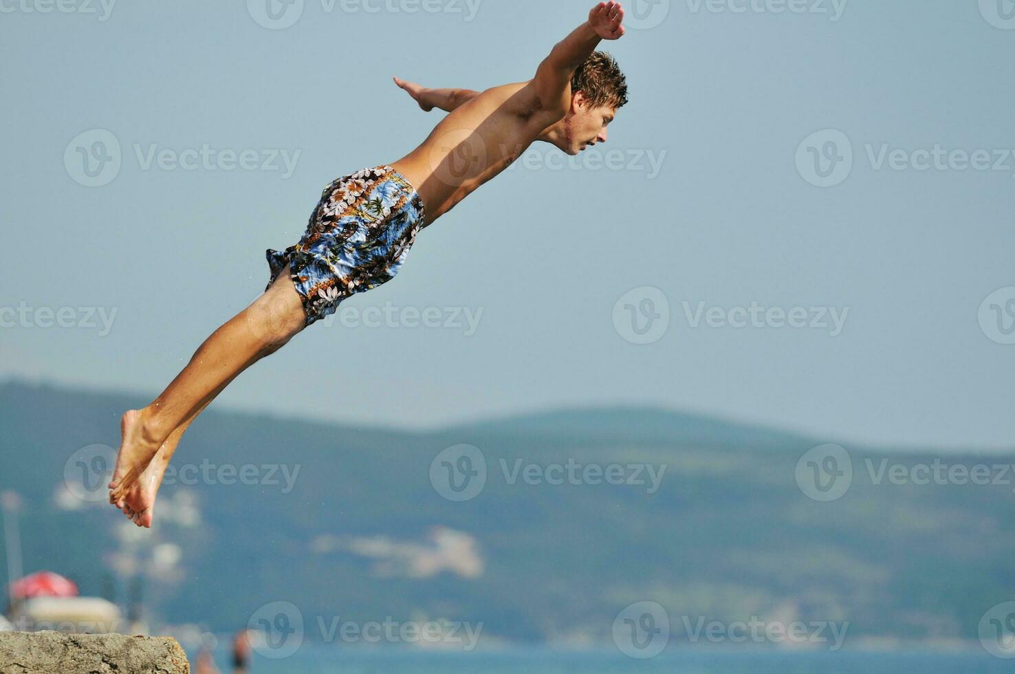 boy jump sea photo