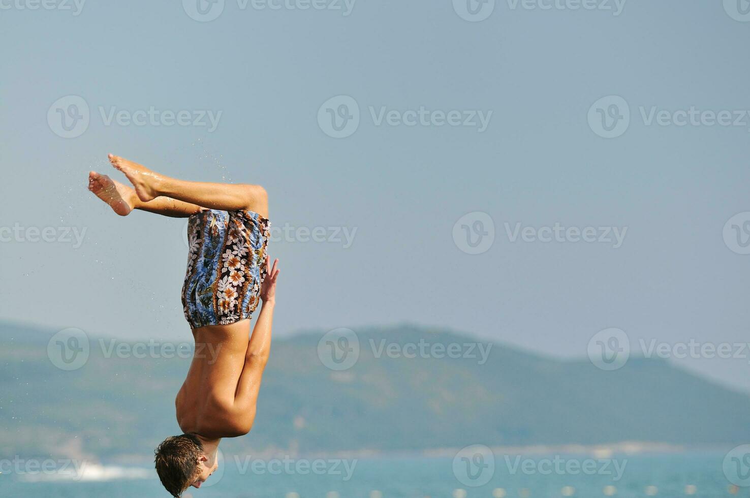 boy jump sea photo