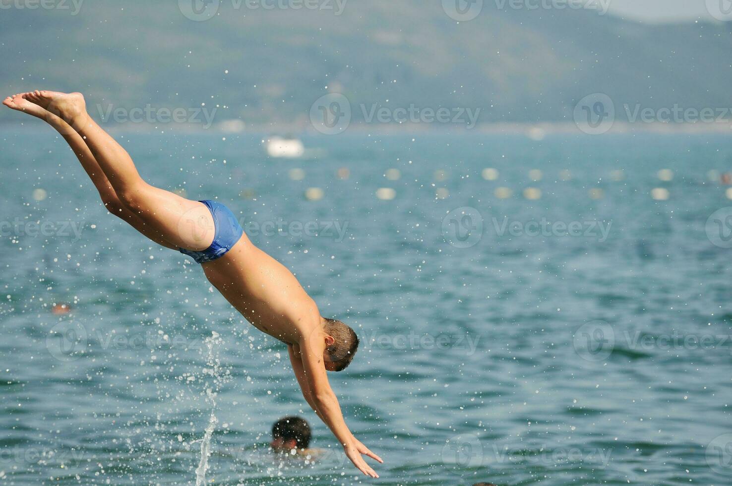 boy jump sea photo