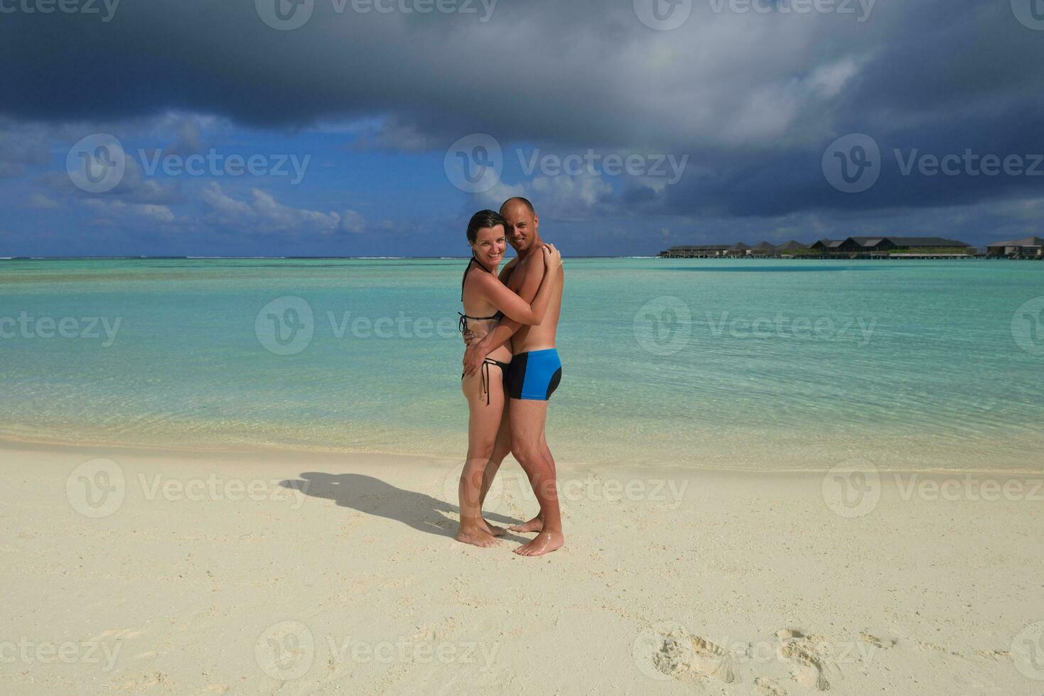 happy young couple have fun on beach photo