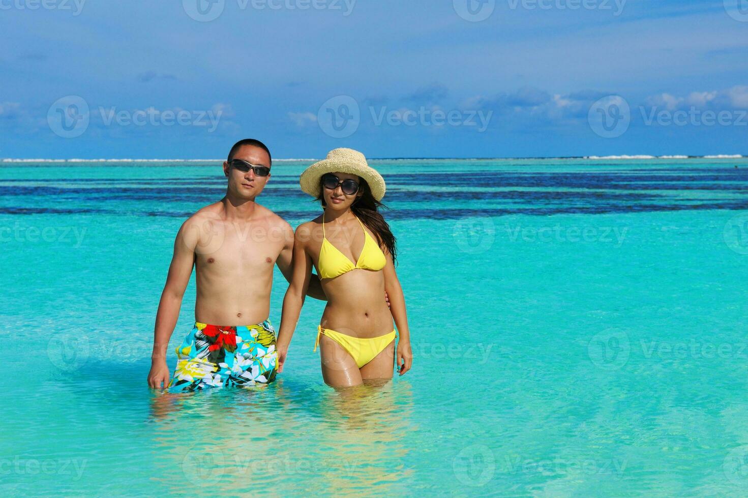 happy young  couple enjoying summer on beach photo