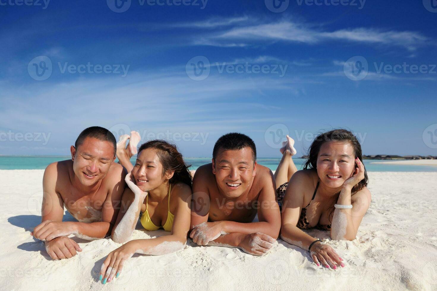 group of happy young people have fun on bach photo