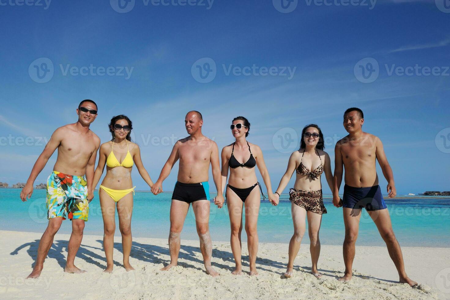 group of happy young people have fun on bach photo