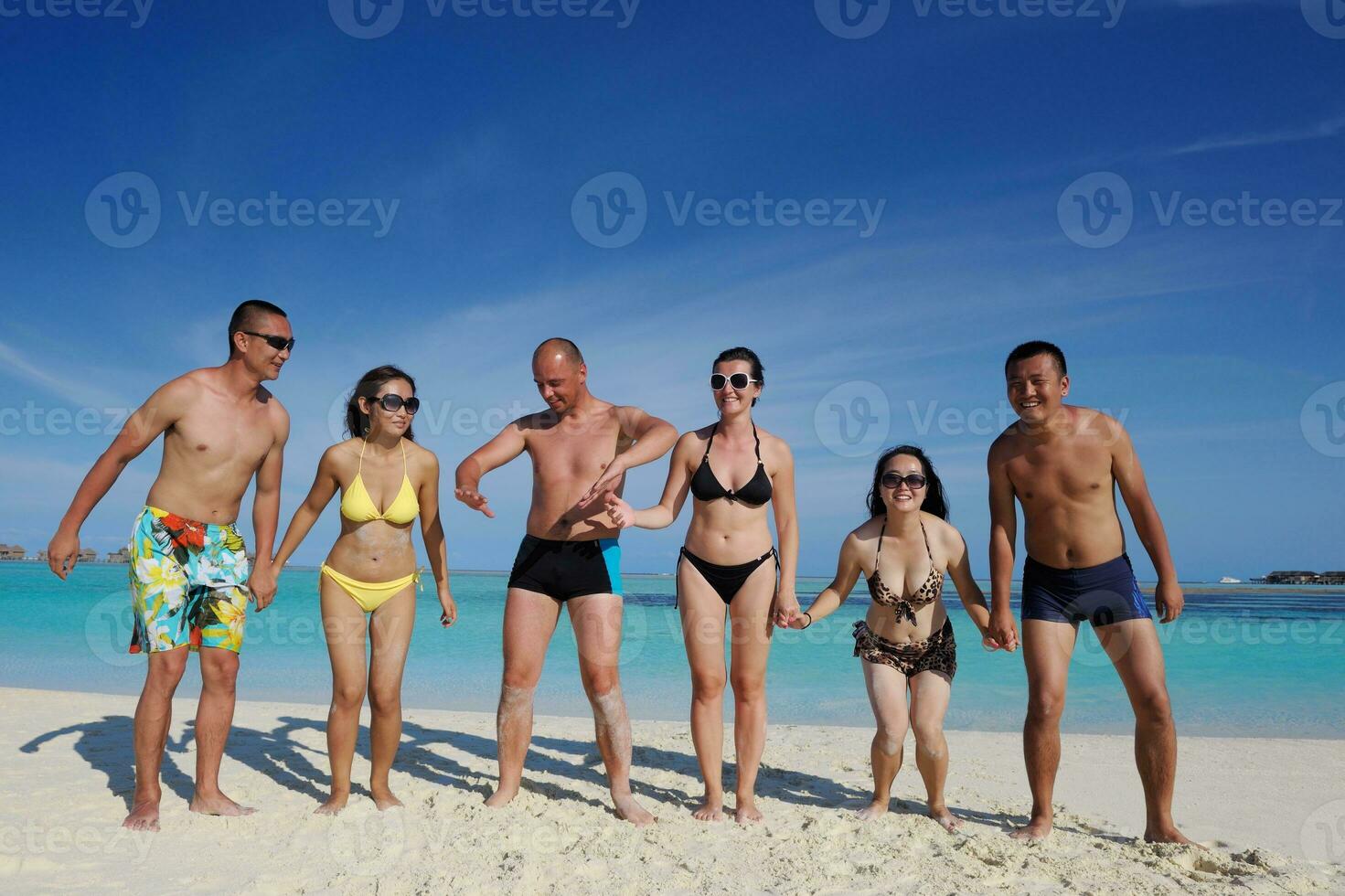group of happy young people have fun on bach photo