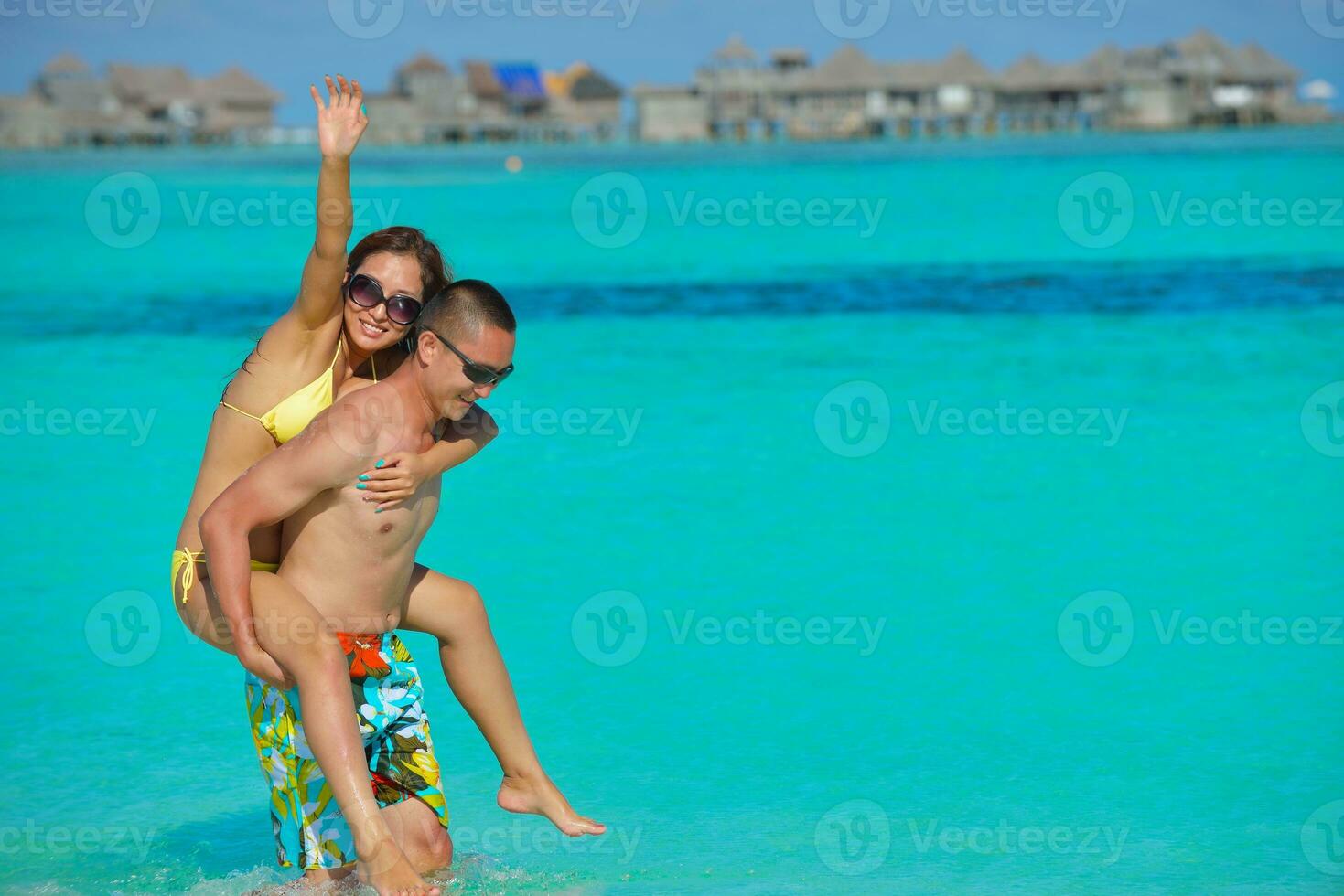 happy young  couple enjoying summer on beach photo