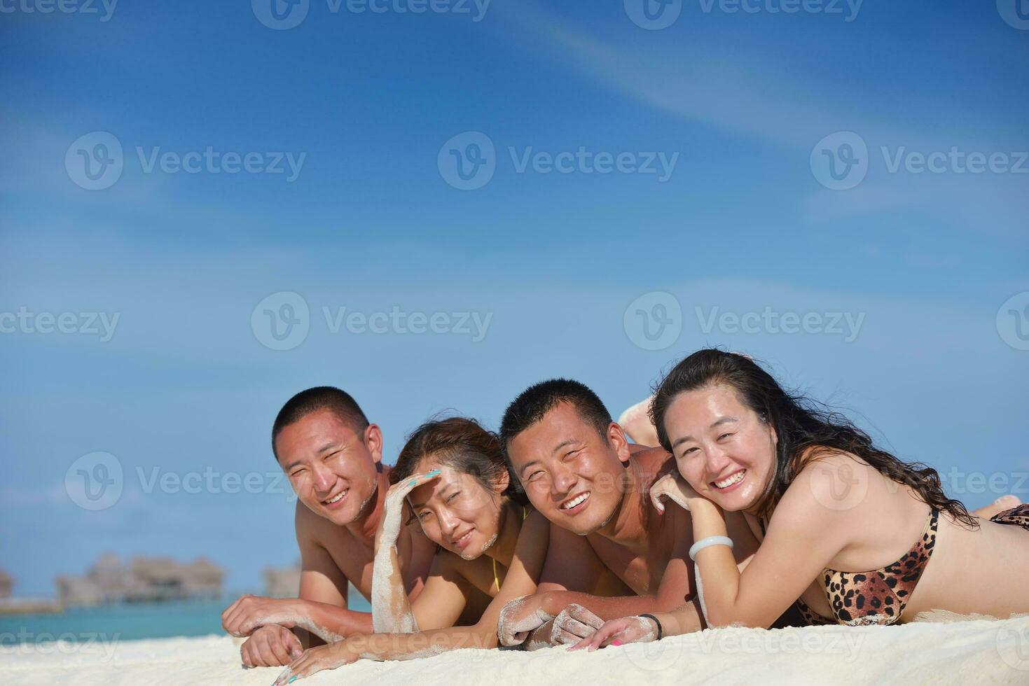 group of happy young people have fun on bach photo