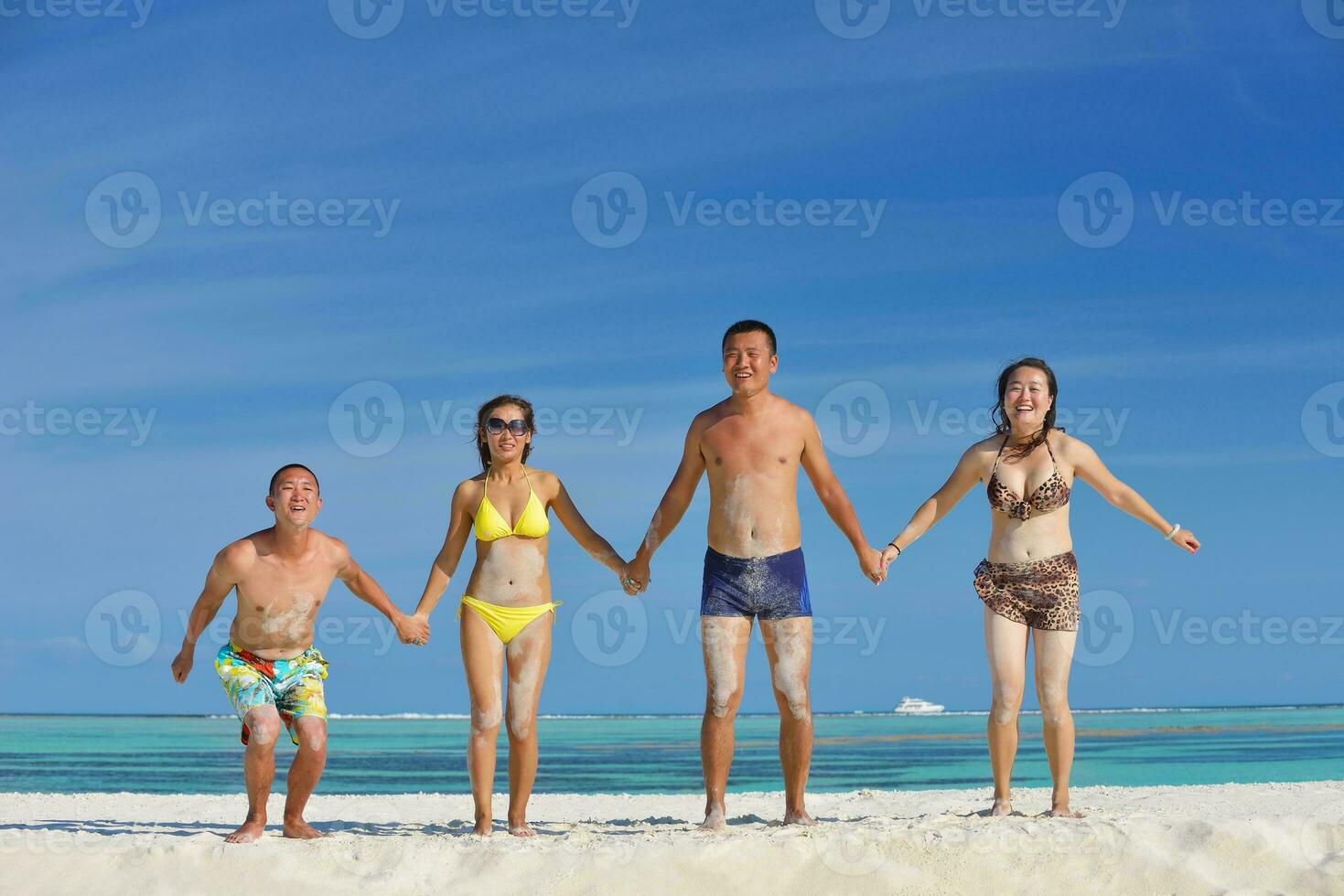 group of happy young people have fun on bach photo