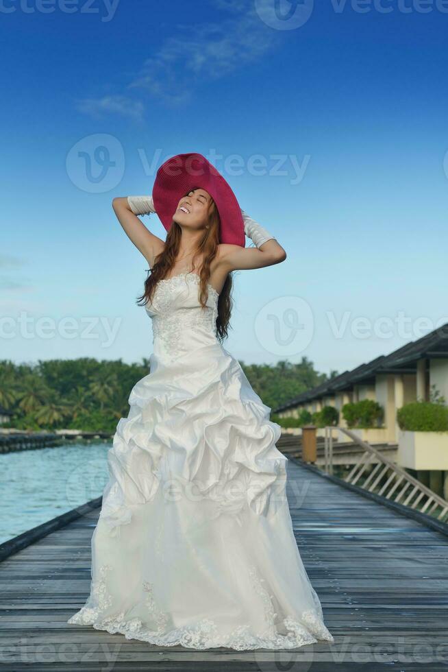 asian bride on beach photo