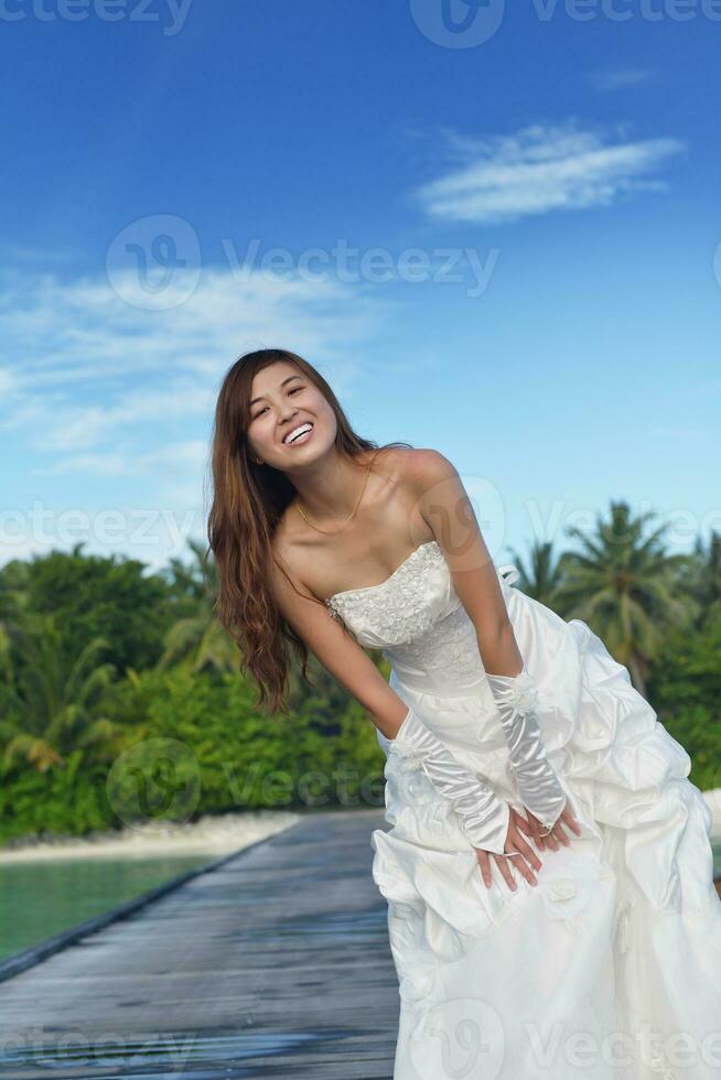 asian bride on beach photo