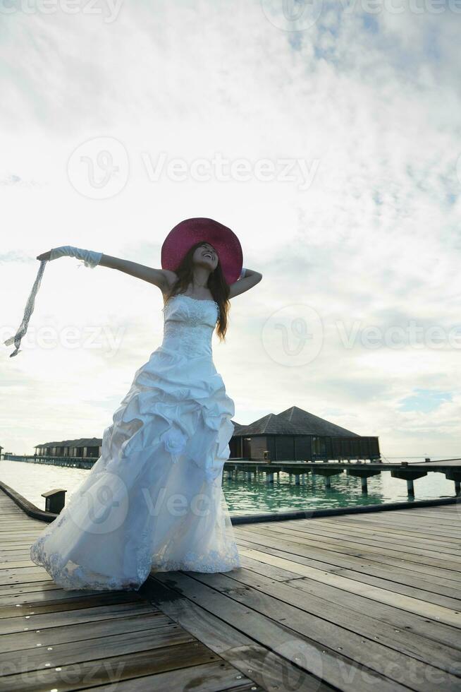 asian bride on beach photo